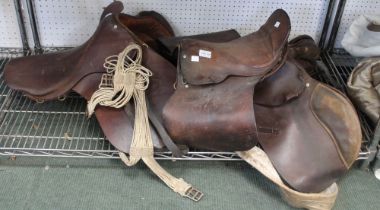 Three vintage leather saddles