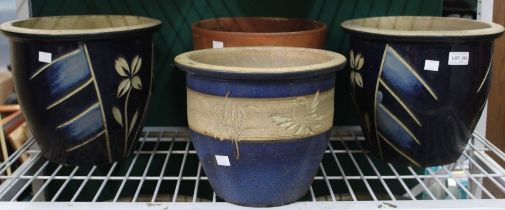Four garden pots including one terracotta and three blue glazed ceramics