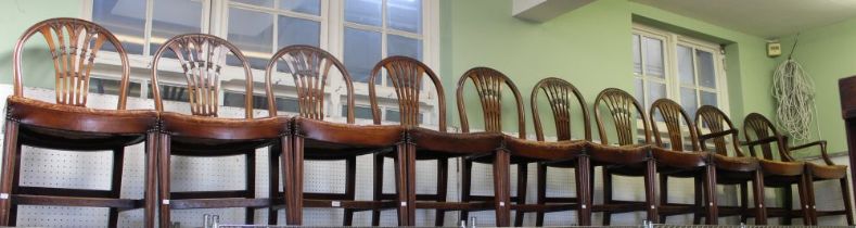 A set of ten mahogany hoop back dining chairs with studded leather seats, 2 carvers