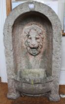 A cast garden water feature with lions head