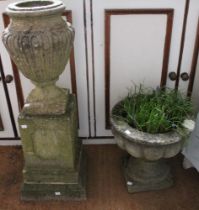 A cast urn on pedestal base with a cast tub garden planter on stand