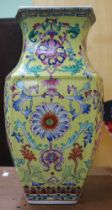 A Chinese ceramic vase of hexagonal form, yellow ground, painted with flowers 43cm high