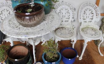 A white painted metal circular garden table and four chairs