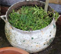 A cast metal circular garden planter