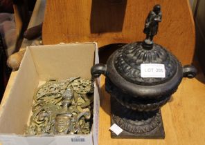 A late 19th century cast iron lidded urn vase, with Napoleon handle to the lid, together with a