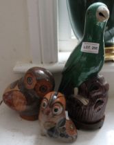 A Chinese ceramic parrot, green glazed, on wooden stand, 31cm high, together with two ceramic Owl or