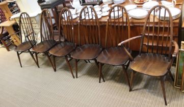 A set of six blue label Ercol dining chairs, including two carvers in dark wood