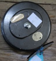 An unbranded 4" fly reel loaded with floating line