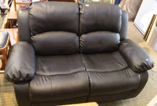 A dark brown leather effect two seater reclining sofa