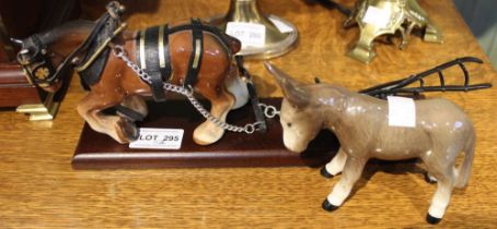 A ceramic model of a heavy horse and plough with a ceramic model of a mule