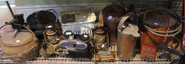 A shelf full of interesting items to include a set of scales and weights, enamel Bread bin