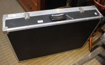 A large black metal bound flight/luggage case