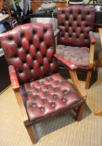 A pair of red leather chesterfield style carver armchairs