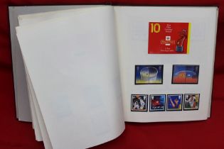 A burgundy GB stamp album