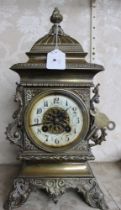 An ornate cast brass cased mantle clock, having 8-day chiming movement with pendulum and key, 35cm h