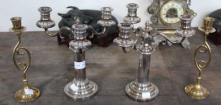 A pair of silver plate three sconce candelabra with a pair of brass candle sticks