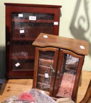 A wooden cased jewellery cabinet with a spoon display cabinet