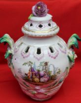 A 19th century Berlin porcelain potpourri, vase form with mask handles, painted in colours with figu