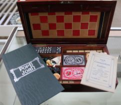 A mahogany cased games compendium, includes chess, draughts, dominoes & a steeple chase game by Ayrs