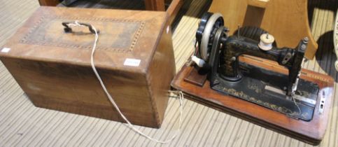 A "Frister and Rossmann" sewing machine in wooden case