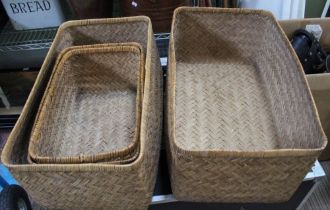 Two woven rush covered storage baskets, with deep lids which double as further open baskets