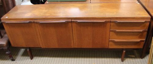A mid century sideboard with a similar period drawer leaf dining table