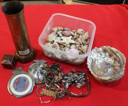 A small box of shells, costume jewellery and a trench art shell