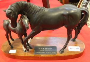 Black Beauty and foal Connoisseur model by Beswick on wooden plinth