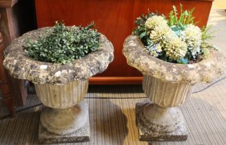 A pair of cast garden urns