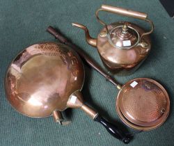 A 19th century copper kettle the cover with acorn finial, together with two copper warming pans (3)