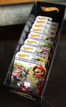 A Hot Wheels MarioKart shop display box containing set of eight models in blister packs