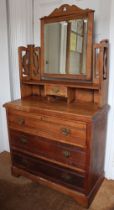 An Edwardian dressing chest fitted drawers and swing mirror