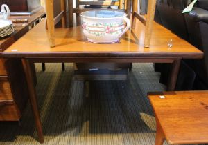 A mid century draw leaf dining table