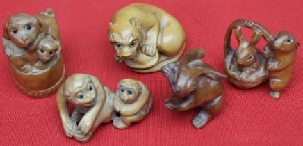 A collection of five Japanese carved wood Netsuke, all as animals, includes Monkey's, Hare's, Temple