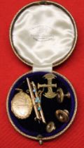 Three 9ct gold studs, a 9ct gold pendant locket, bar brooch and yellow metal axe brooch, gross weigh