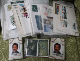 Two packs of Saddam Husayn Al-Tikriti playing cards and a collection of First Day Covers