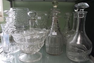 A shelf of glass decanters and cut glass vases etc
