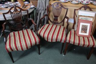 A pair of Victorian mahogany Sheraton shield back carver chairs with tapestry upholstery with anothe