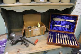 A cased set of fish knives and forks with two vintage spong style mincers