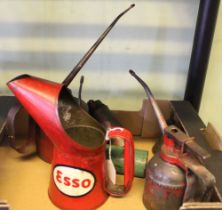 A red "Esso" oil can, together with other oil dispensers (6)