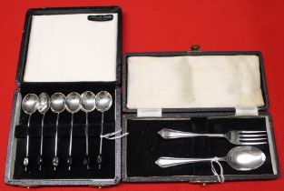 A cased set of silver coffee bean spoons and another cased silver spoon and fork set