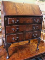 A mahogany reproduction three drawer drop-front bureau