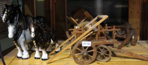 Three ceramic Shire Horses, together with three carts