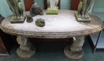 A cast oval table supported by two otters