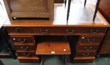 A modern yew wood twin pedestal desk with leather insert top