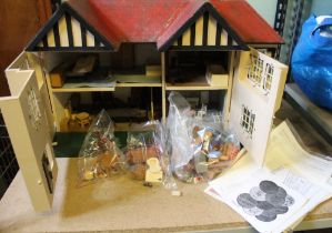 A mid 20th century Triang manufactured dolls house to include furniture and associated literature