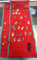 A collection of 31 Robertson's "Golly" badges on two fabric "Golly Brooch Collection" red felt rolls