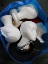 A bag containing polystyrene mannequin heads, hats etc