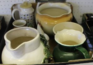 A box containing a selection of domestic ceramic jugs, etc