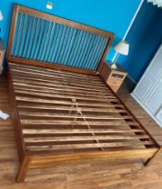 A modern hardwood slat back super King size bed